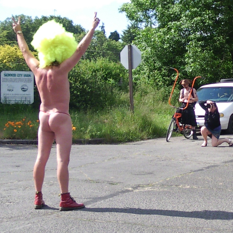 Man in outrageous wig at the World Naked Bike Ride Eugene
